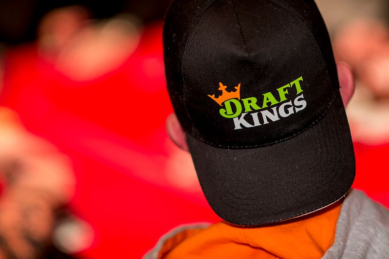 DraftKings topped second-quarter earnings estimates, raised fiscal year revenue guidance and intimated the introduction of a gaming tax