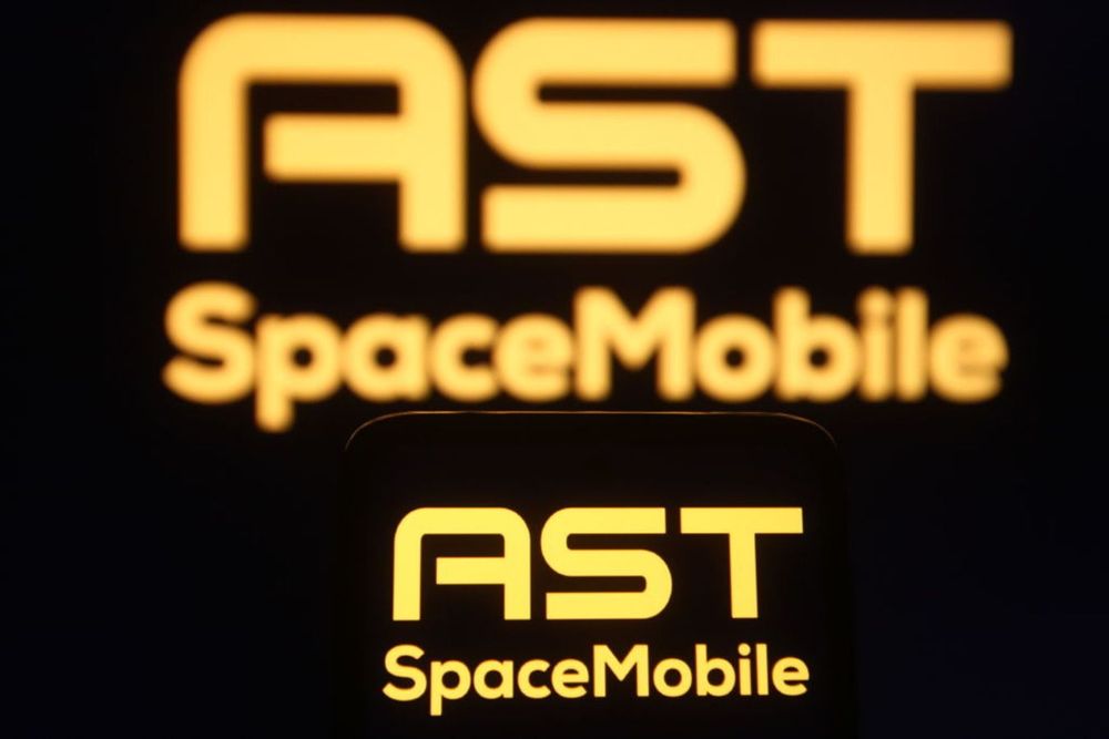  In this photo illustration the AST SpaceMobile logo is seen on a smartphone and a pc screen.