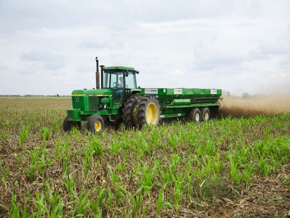 A spreader wagon pulled by a John Deere tractor applies poultry litter as fertilizer to a field of corn stubble in Autumn. (Photo by: Bill Barksdale/Design Pics Editorial/Universal Images Group via Getty Images)
