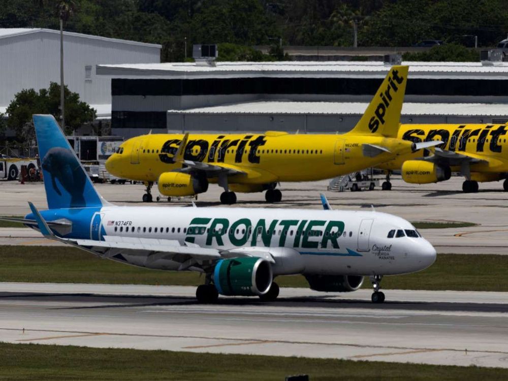 A Frontier Airlines plane near a Spirit Airlines plane at the Fort Lauderdale-Hollywood International Airport on May 16, 2022 in Fort Lauderdale, Florida. (Photo by Joe Raedle/Getty Images)