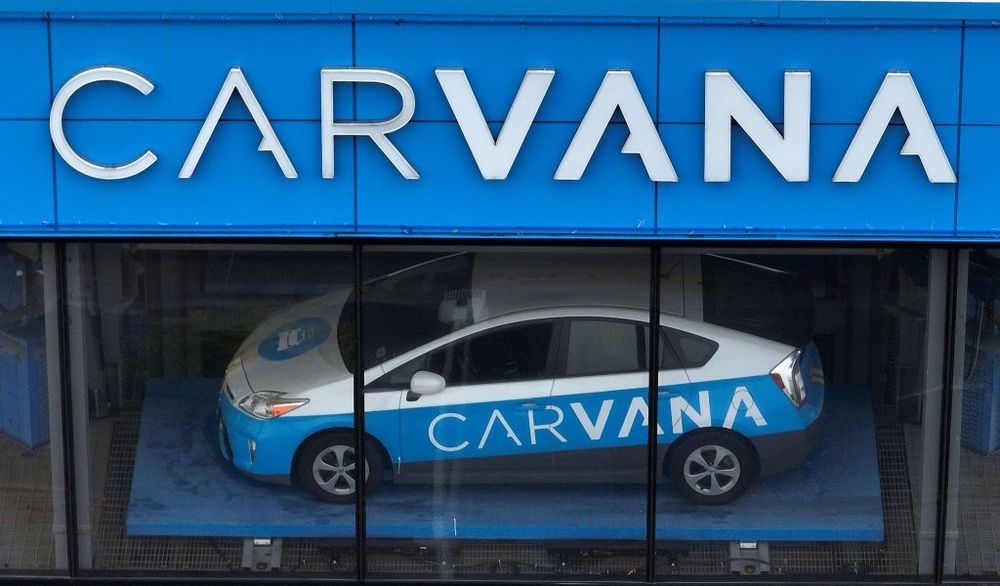  In an aerial view, a sign is posted on the exterior of a Carvana car vending machine on July 19, 2023 in Daly City, California.