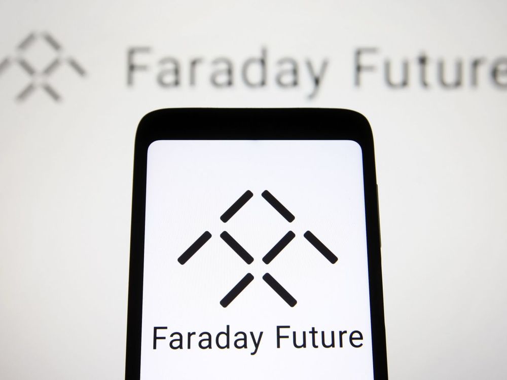 In this photo illustration, a Faraday Future Intelligent Electric Inc. logo is seen on a smartphone and a computer screen. (Photo Illustration by Pavlo Gonchar/SOPA Images/LightRocket via Getty Images)
