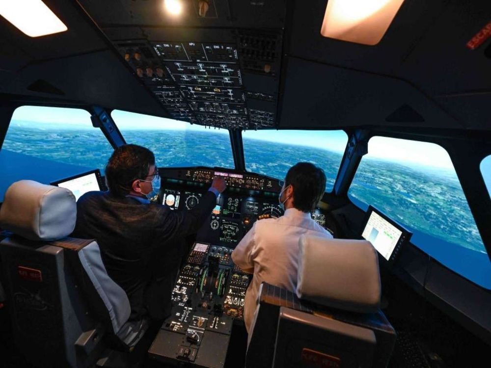 Pilots using the controllers inside a flight simulator. (Photo by: Soudan E/Alpaca/Andia/Universal Images Group via Getty Images)