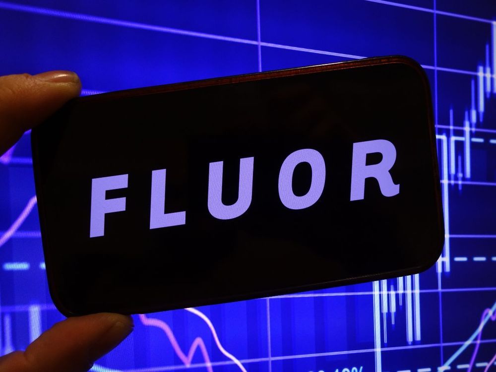 In this photo illustration, the Fluor Corporation company logo is seen displayed on a smartphone screen. (Photo Illustration by Piotr Swat/SOPA Images/LightRocket via Getty Images)