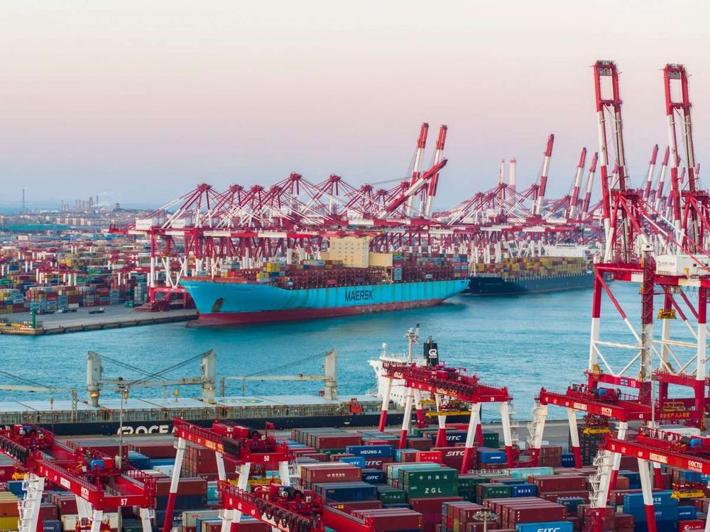 A cargo ship loads containers at a container terminal