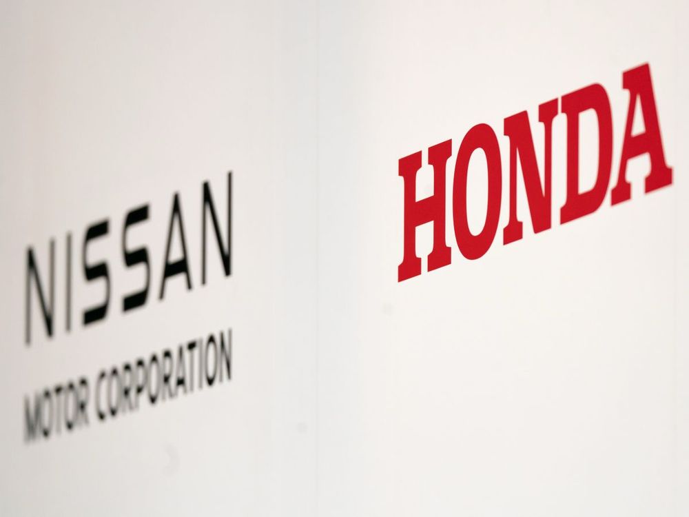 Nissan Motor and Honda Motor logos are seen during a joint press conference on December 23, 2024, in Tokyo, Japan. (Photo by Tomohiro Ohsumi/Getty Images)