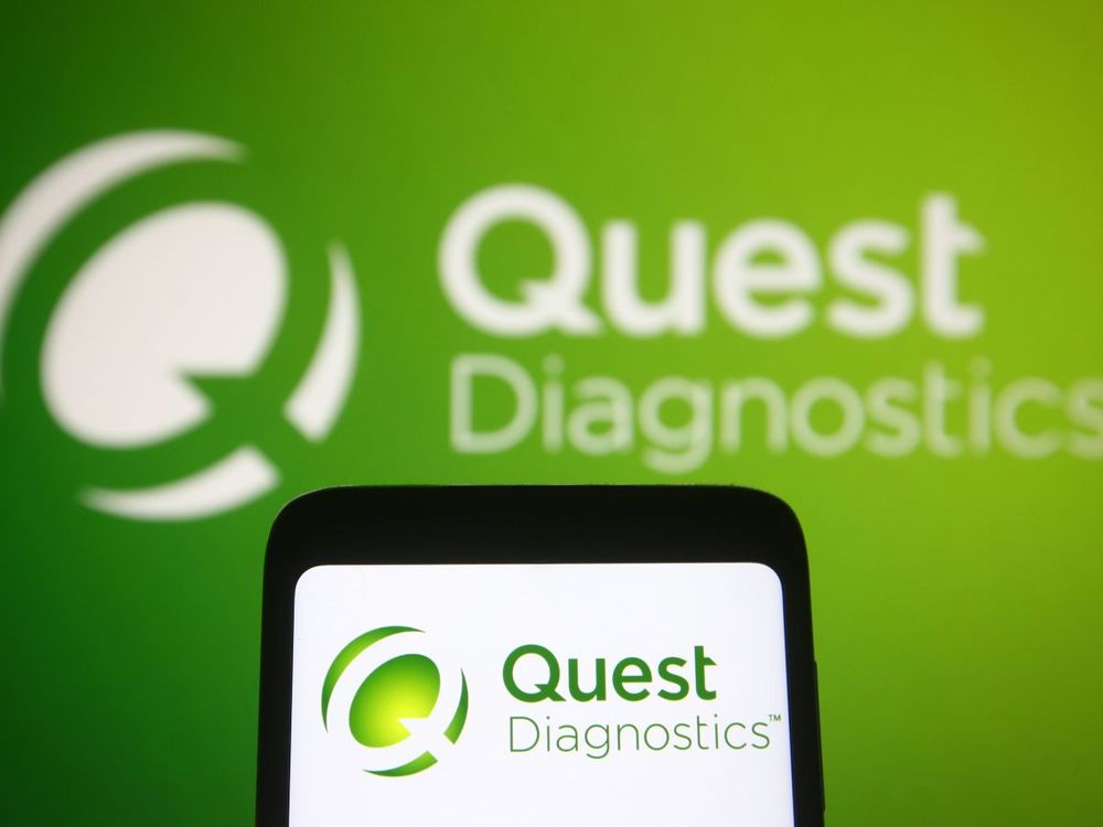 In this photo illustration, Quest Diagnostics logo of a US clinical laboratory is displayed on a smartphone and pc screen. (Photo Illustration by Pavlo Gonchar/SOPA Images/LightRocket via Getty Images)