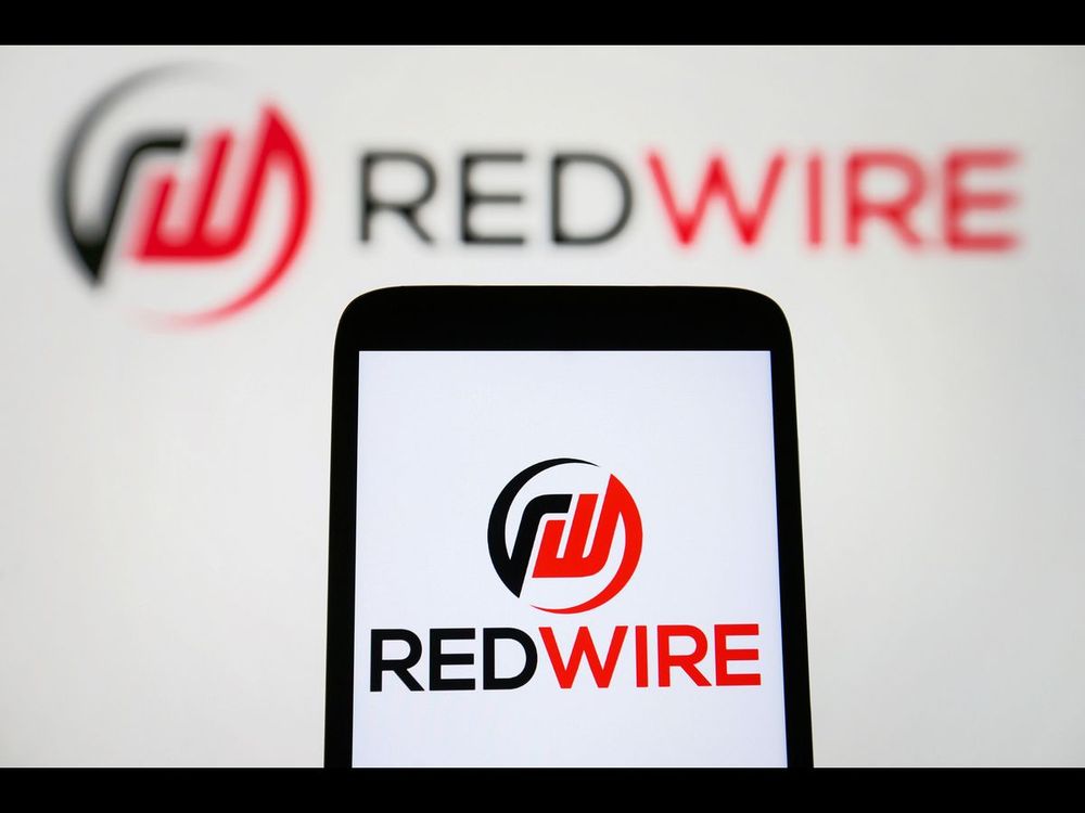 In this photo illustration, a Redwire Corporation logo is seen on a smartphone and on a pc screen. (Photo Illustration by Pavlo Gonchar/SOPA Images/LightRocket via Getty Images)