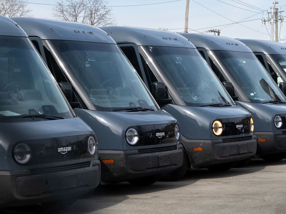 Amazon delivery trucks built by Rivian sit in a lot at a Rivian facility on February 22, 2024, in Chicago, Illinois. (Photo by Scott Olson/Getty Images)