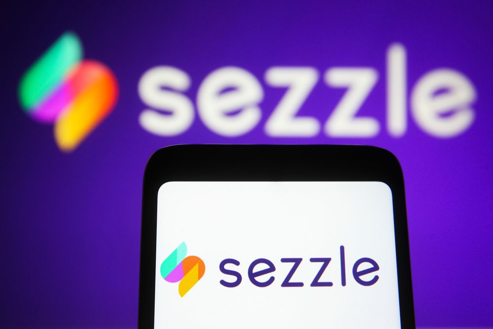 In this photo illustration, the logo of Sezzle logo, a financial technology company is displayed on a smartphone screen and in the background. (Photo Illustration by Pavlo Gonchar/SOPA Images/LightRocket via Getty Images)