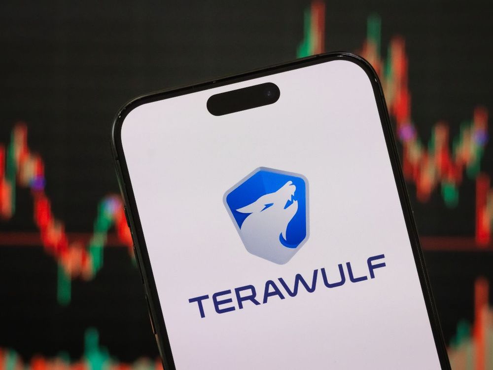 In this photo illustration, the TeraWulf logo is displayed on a smartphone screen, with the company's latest stock market performance and candlestick charts visible in the background.  (Photo by Cheng Xin/Getty Images)